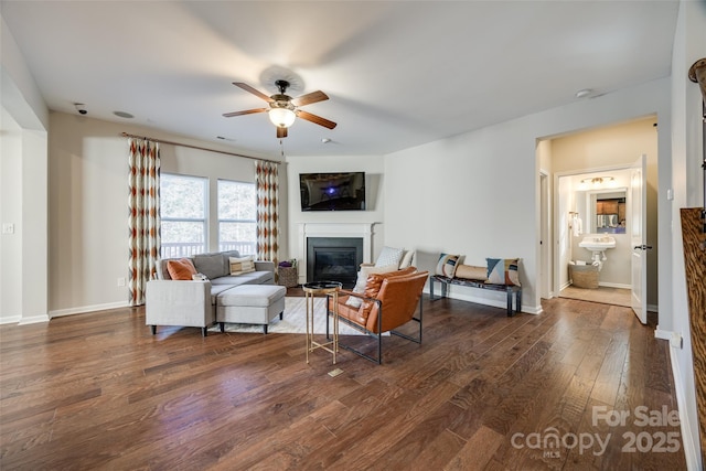 living room with dark hardwood / wood-style floors and ceiling fan