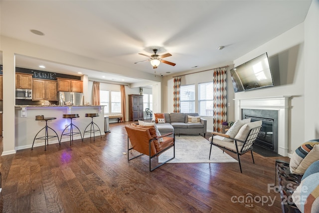 living room with dark hardwood / wood-style floors and ceiling fan