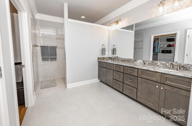 bathroom featuring vanity, tile patterned floors, and crown molding