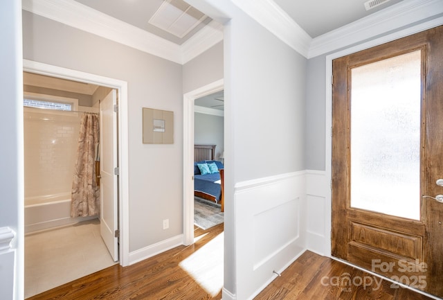 foyer with dark hardwood / wood-style flooring and crown molding