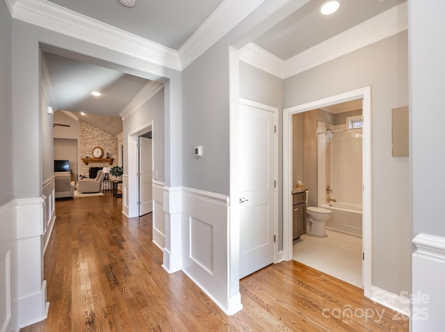 hall featuring ornamental molding and hardwood / wood-style flooring