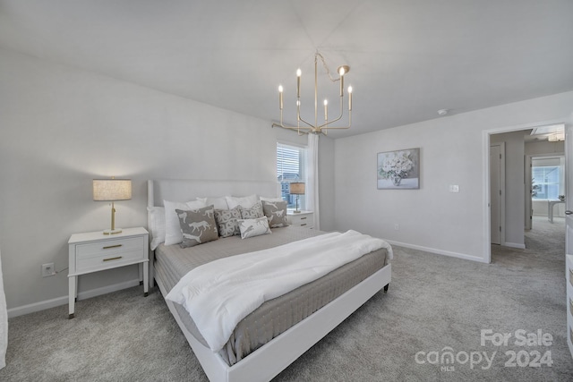 bedroom with light carpet, multiple windows, and a notable chandelier