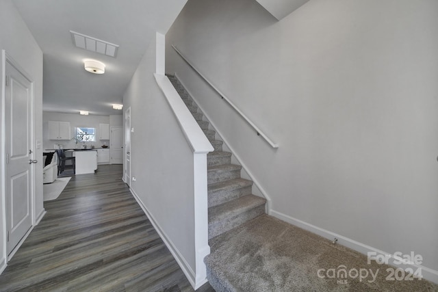 staircase with wood-type flooring