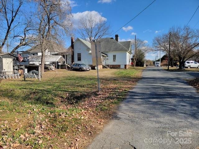 view of side of property with a lawn