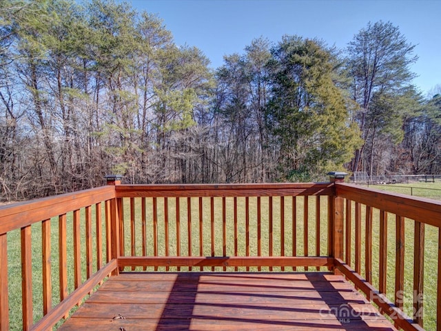 wooden deck with a lawn