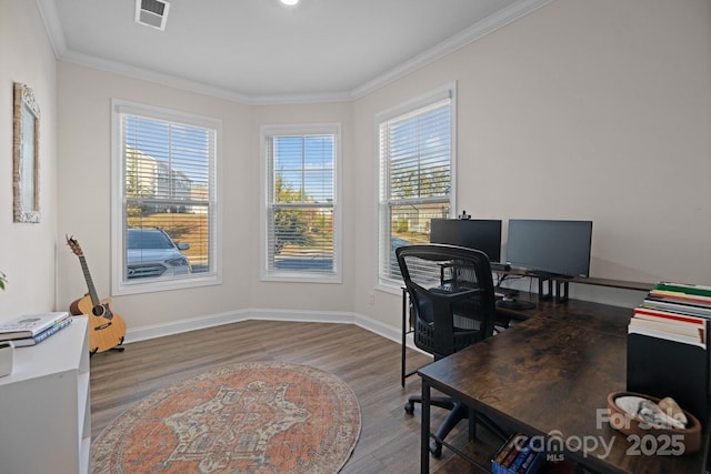 office space featuring wood finished floors, visible vents, plenty of natural light, and ornamental molding