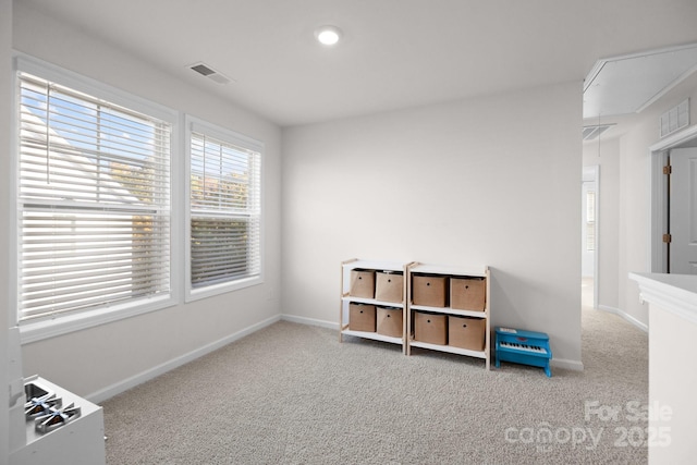 interior space featuring visible vents, carpet, and attic access