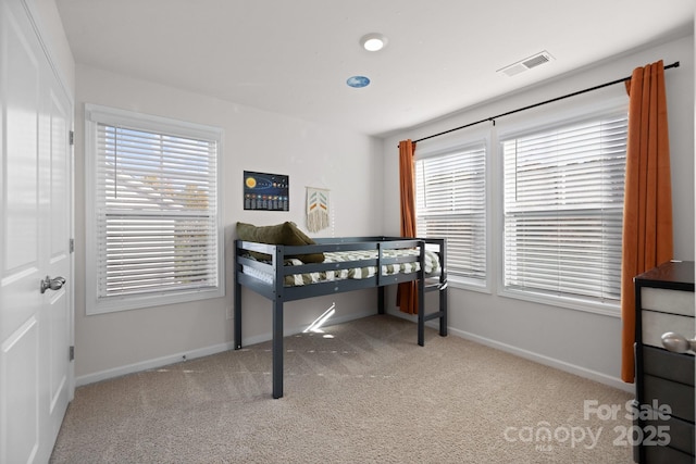 carpeted bedroom with baseboards and visible vents