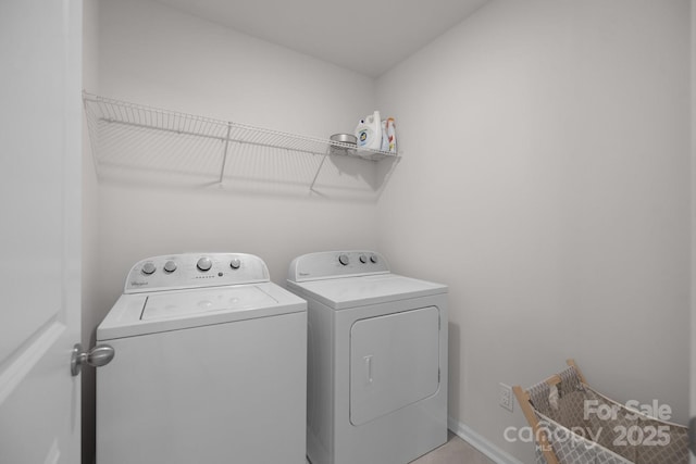 laundry area featuring washer and dryer, laundry area, and baseboards