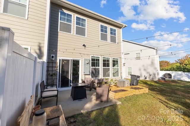 rear view of property with a garden, a patio, a lawn, and fence