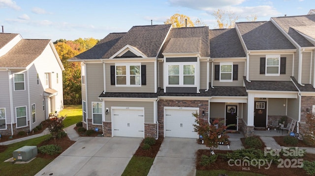 townhome / multi-family property featuring a garage, stone siding, roof with shingles, and concrete driveway