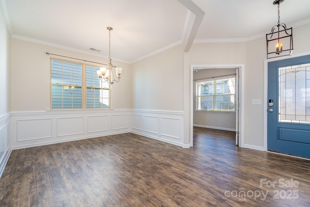 entrance foyer featuring a notable chandelier, dark hardwood / wood-style flooring, and ornamental molding