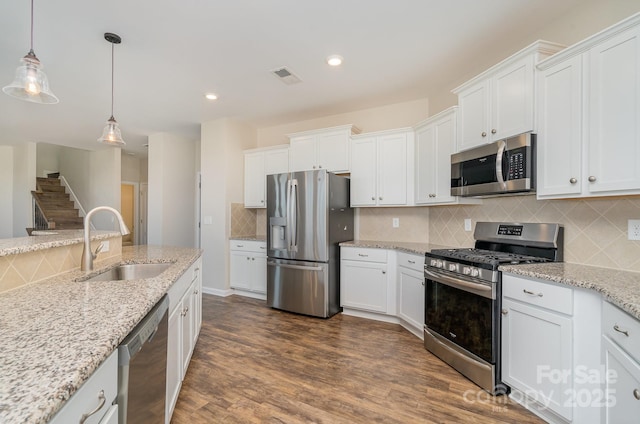 kitchen featuring white cabinets, sink, and stainless steel appliances