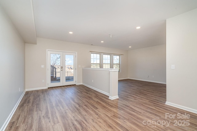 empty room with hardwood / wood-style floors and french doors