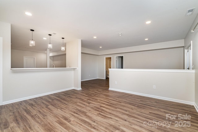 unfurnished room with wood-type flooring