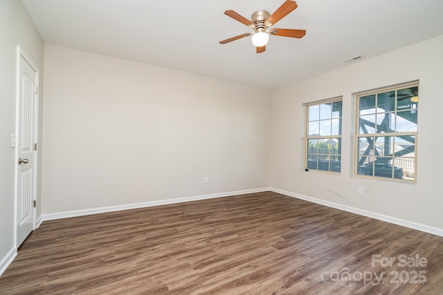 spare room with ceiling fan and dark hardwood / wood-style flooring