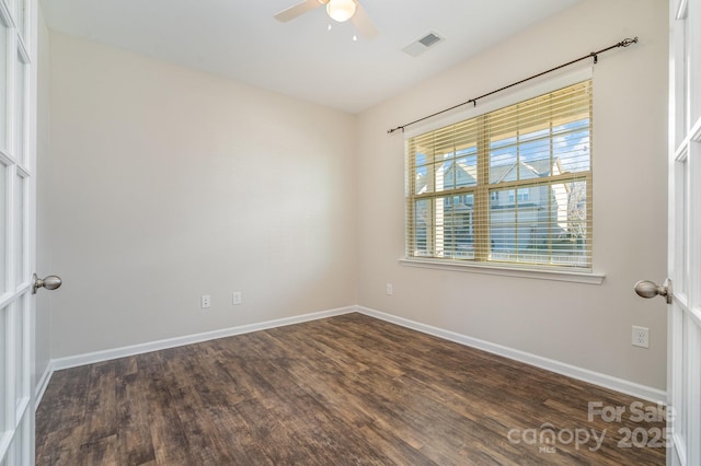 unfurnished room with ceiling fan and dark wood-type flooring