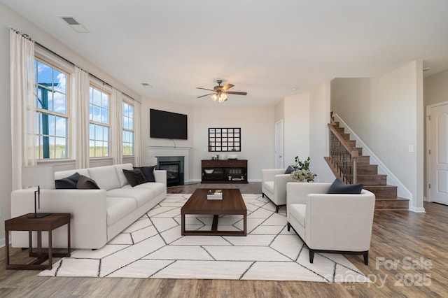 living room featuring light hardwood / wood-style floors and ceiling fan