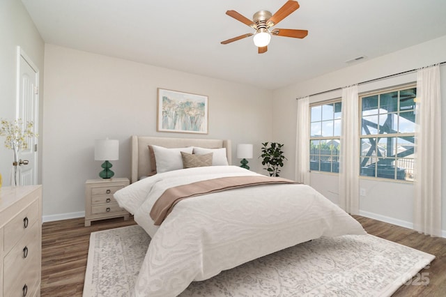 bedroom featuring ceiling fan and dark hardwood / wood-style floors