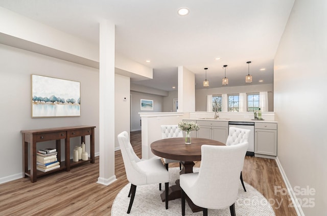 dining area with light wood-type flooring and sink