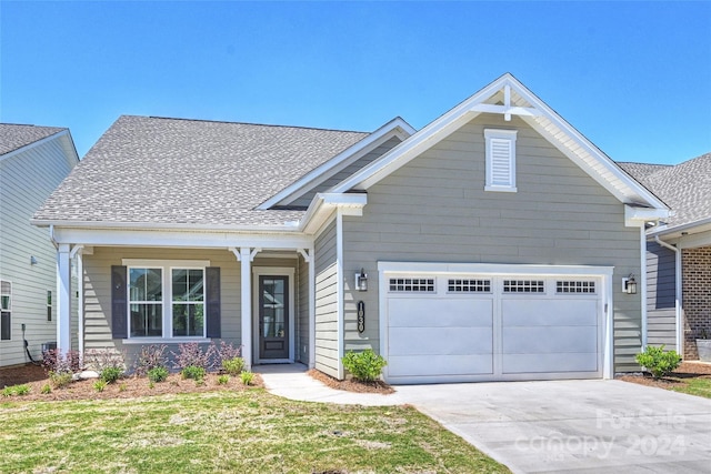 craftsman-style house with a garage and a front lawn