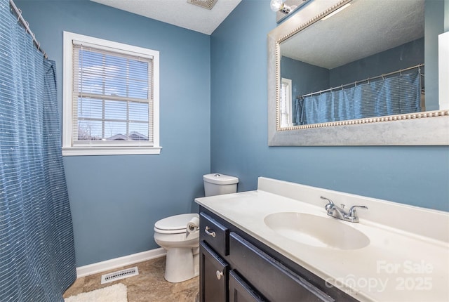 bathroom with a textured ceiling, toilet, and vanity