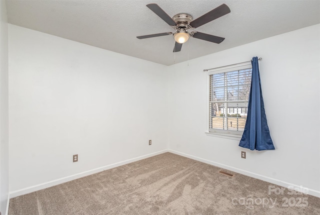 carpeted empty room with a textured ceiling