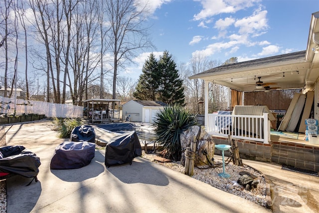 exterior space with ceiling fan and a storage shed