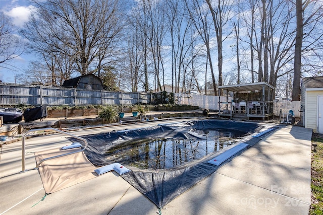 view of pool featuring a patio area and an outdoor structure