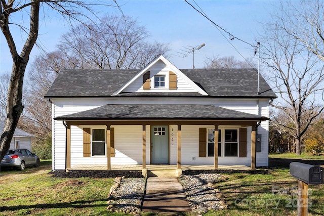 view of front of property with a porch and a front lawn