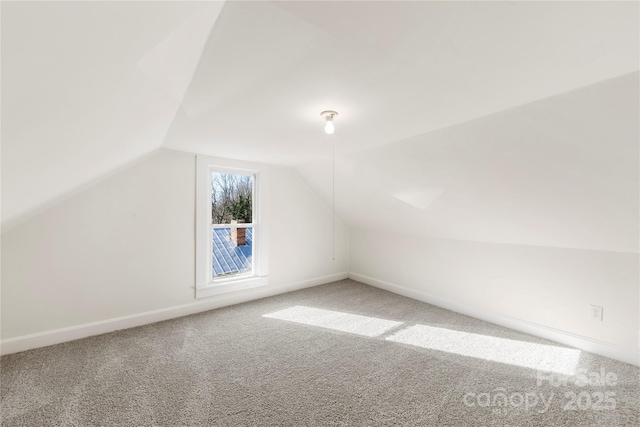 bonus room featuring carpet flooring and vaulted ceiling