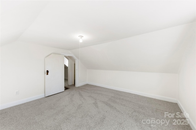 bonus room featuring carpet flooring and vaulted ceiling