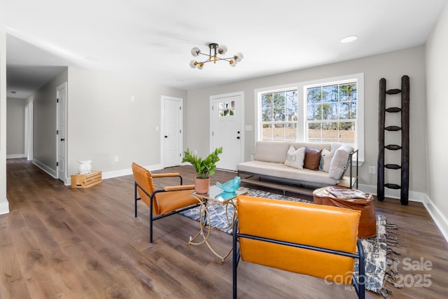 living room featuring a chandelier and dark hardwood / wood-style floors