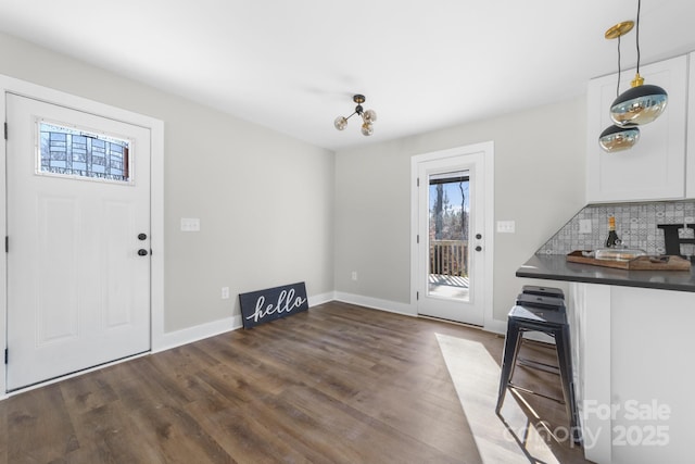 unfurnished dining area with dark wood-type flooring