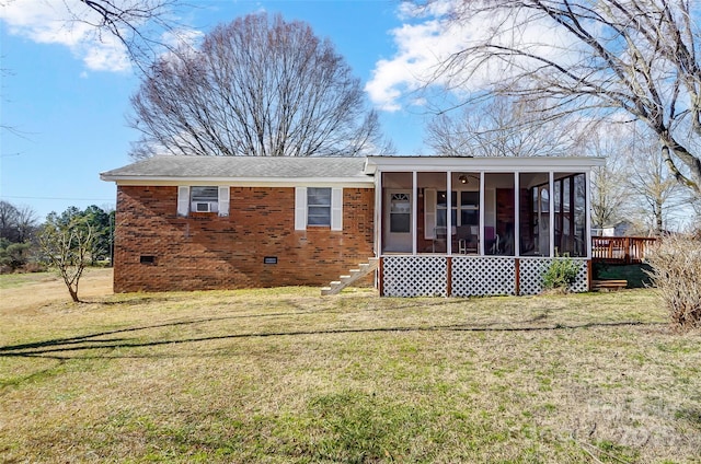 back of property with a lawn and a sunroom