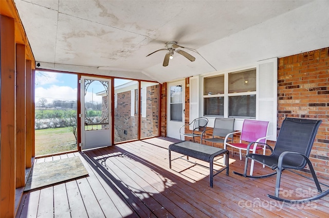 sunroom with lofted ceiling and ceiling fan