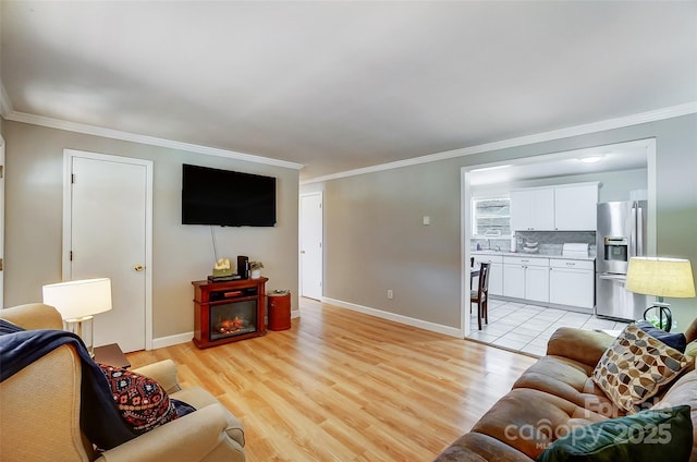 living room featuring light hardwood / wood-style floors and ornamental molding