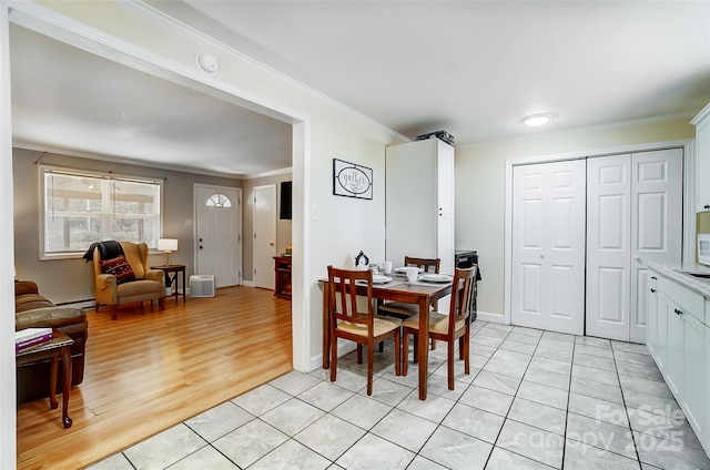 tiled dining room with ornamental molding