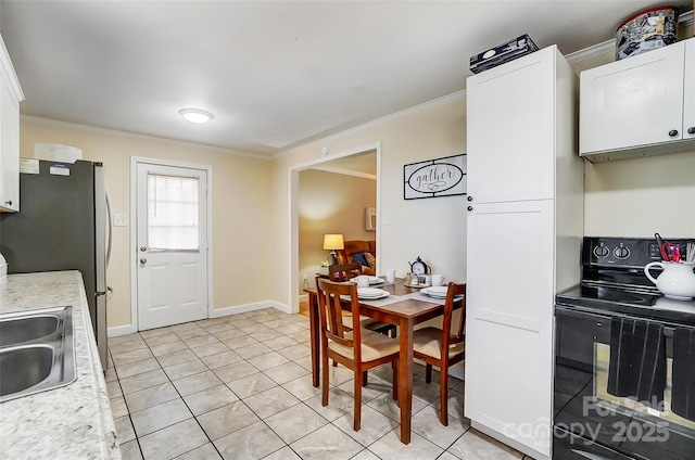 kitchen featuring white cabinets, black range with electric cooktop, and crown molding