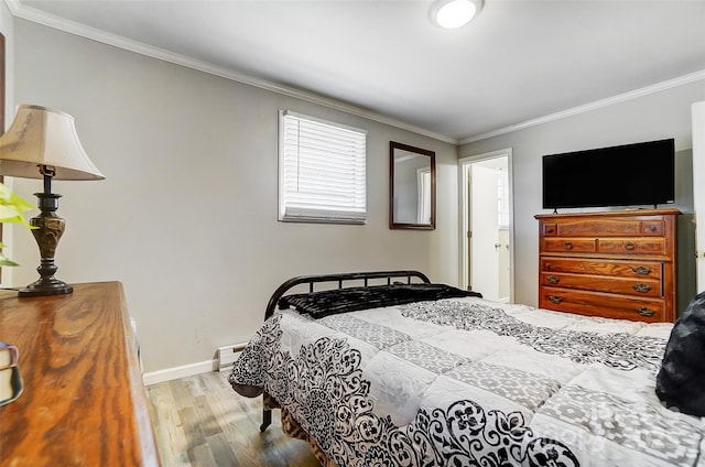 bedroom featuring light wood-type flooring, crown molding, and a baseboard heating unit