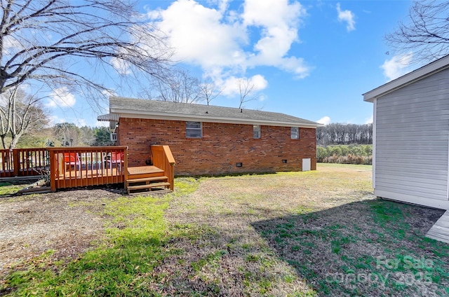 rear view of property with a lawn and a wooden deck