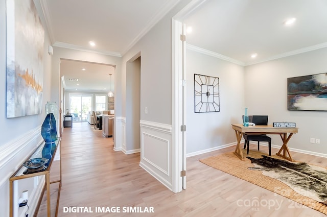 office area with light hardwood / wood-style floors and ornamental molding