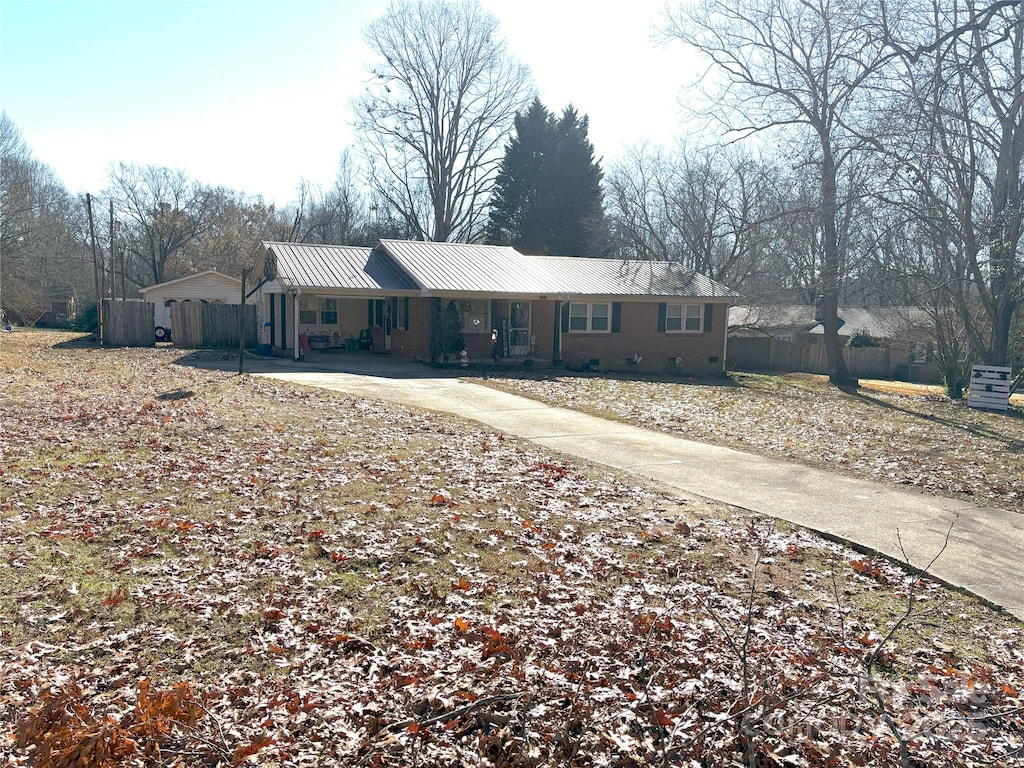 1432 Poston Dr, Lincolnton, NC 28092 - ranch-style house with metal roof, concrete driveway, and fence