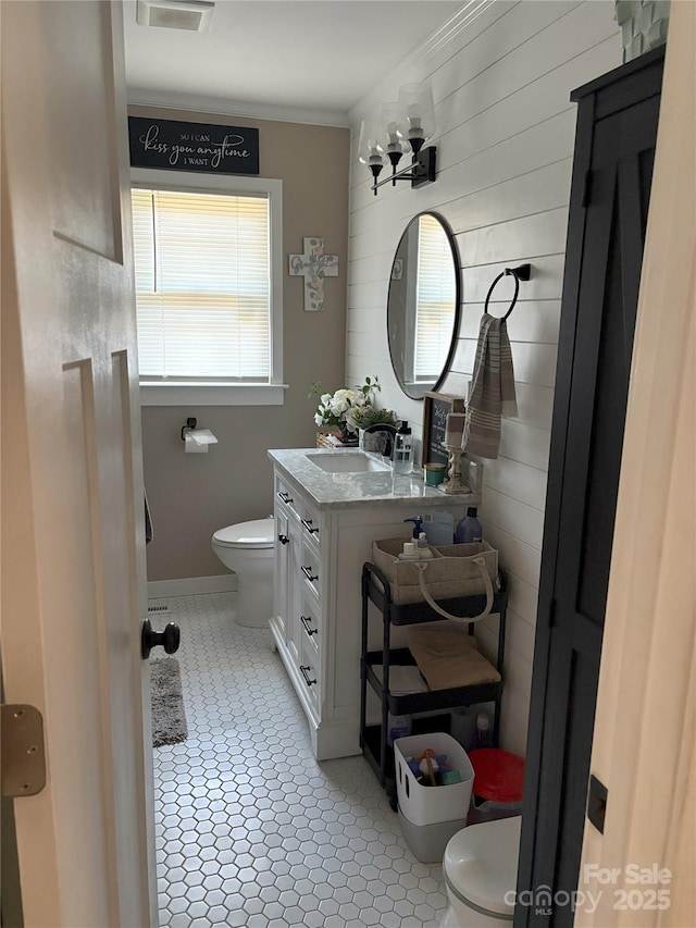 bathroom featuring vanity, toilet, and crown molding