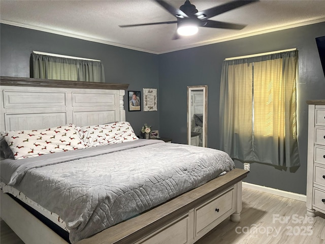 bedroom with ceiling fan, light hardwood / wood-style floors, a textured ceiling, and ornamental molding