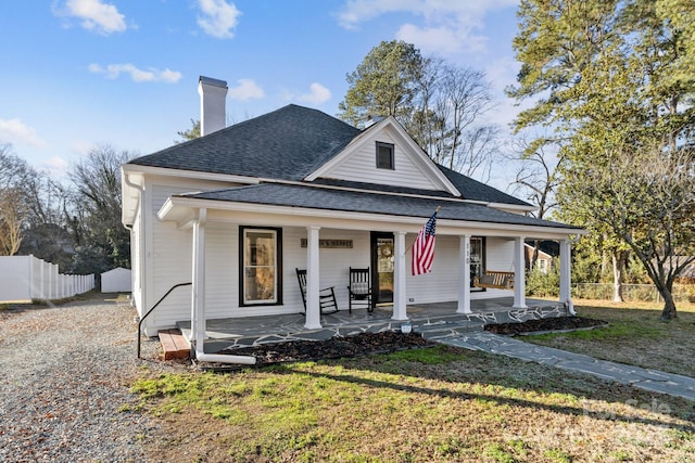 view of front of house with covered porch and a front yard