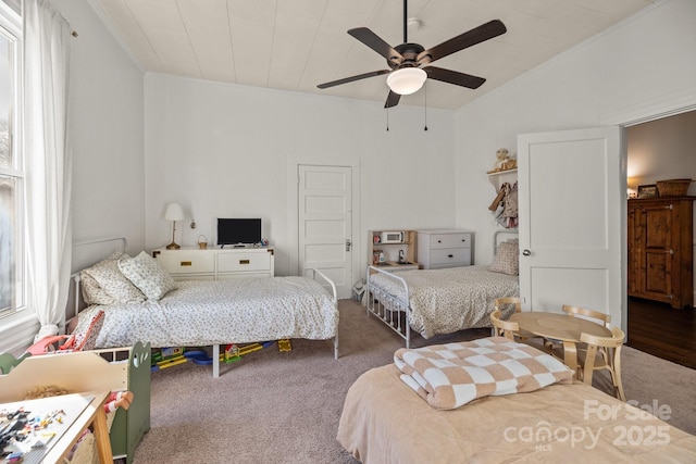 bedroom featuring lofted ceiling, carpet floors, and ceiling fan