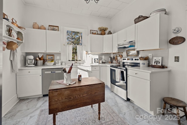 kitchen featuring white cabinetry, stainless steel appliances, and decorative backsplash