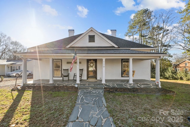 view of front of house with a porch and a front yard