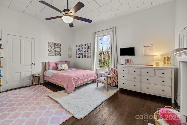 bedroom with ceiling fan and dark hardwood / wood-style flooring